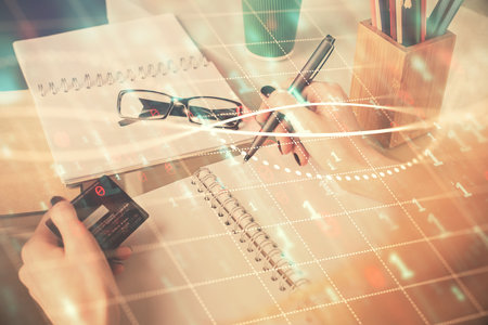 Multi exposure of woman on-line shopping holding a credit card and financial graph drawing. Stock market E-commerce concept.の写真素材