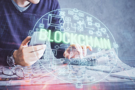Double exposure of man's hands holding and using a phone and crypto currency blockchain theme drawing.の写真素材