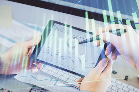 Double exposure of man's hands holding and using a phone and financial chart drawing. Market analysis concept.の写真素材