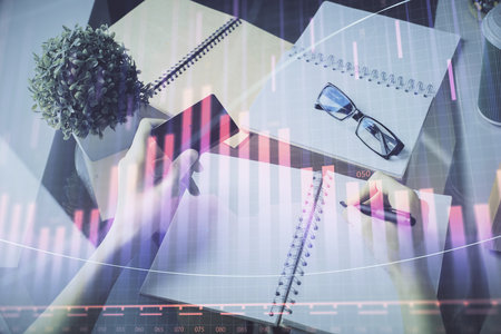 Multi exposure of woman on-line shopping holding a credit card and financial graph drawing. Stock market E-commerce concept.の写真素材