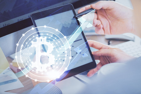 Double exposure of man's hands holding and using a phone and crypto currency blockchain theme drawing.の写真素材
