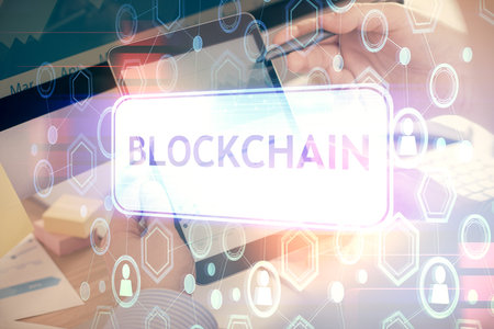 Double exposure of man's hands holding and using a phone and crypto currency blockchain theme drawing.の写真素材