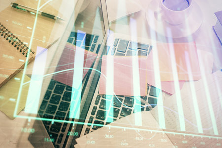 Multi exposure of financial chart drawing over table background with computer. Concept of research and analysis. Top view.の写真素材