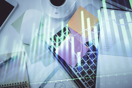 Multi exposure of financial chart drawing over table background with computer. Concept of research and analysis. Top view.の写真素材