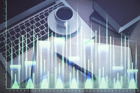 Stock market graph and top view computer on the table background. Multi exposure. Concept of financial education.の写真素材