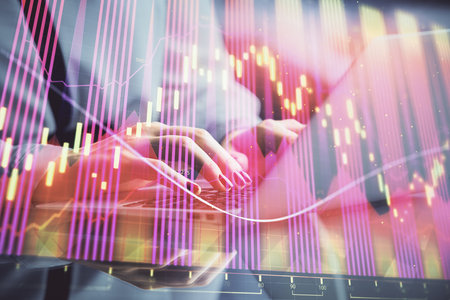 Double exposure of businesswoman hands typing on computer and forex chart hologram drawing. Financial analysis concept.の写真素材