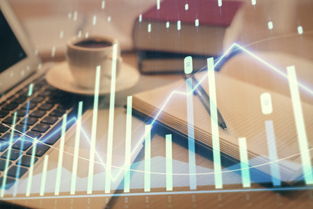 Double exposure of financial chart drawing and desktop with coffee and items on table background. Concept of forex market tradingの写真素材