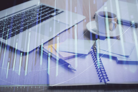 Multi exposure of forex graph drawing and desktop with coffee and items on table background. Concept of financial market tradingの写真素材