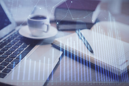 Double exposure of forex chart drawing and desktop with coffee and items on table background. Concept of financial market tradingの写真素材
