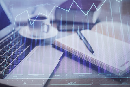Double exposure of forex chart drawing and desktop with coffee and items on table background. Concept of financial market tradingの写真素材