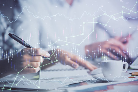 Double exposure of forex graph drawing over people taking notes background. Concept of financial analysisの写真素材