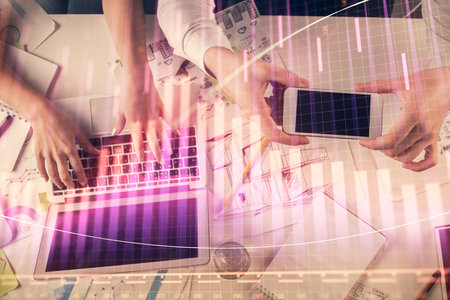 Multi exposure of man and woman working together and forex graph hologram drawing. Financial analysis concept. Computer background. Top View.の写真素材