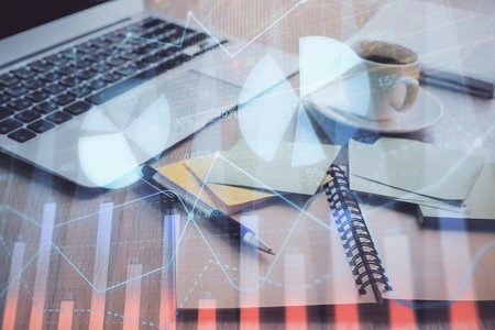 Multi exposure of forex graph drawing and desktop with coffee and items on table background. Concept of financial market tradingの写真素材