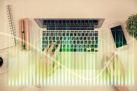 Double exposure of woman hands working on computer and forex chart hologram drawing. Top View. Financial analysis concept.の写真素材