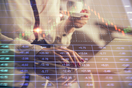 Double exposure of businesswoman hands typing on computer and financial graph hologram drawing. Stock market analysis concept.の写真素材