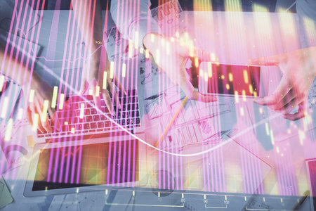 Multi exposure of man and woman working together and forex graph hologram drawing. Financial analysis concept. Computer background. Top View.の写真素材