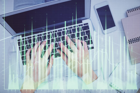 Double exposure of woman hands working on computer and forex chart hologram drawing. Top View. Financial analysis concept.の写真素材