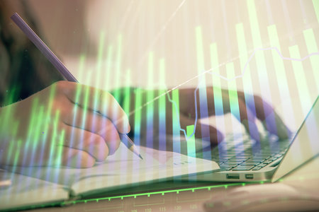 Double exposure of businesswoman hands typing on computer and forex chart hologram drawing. Financial analysis concept.の写真素材