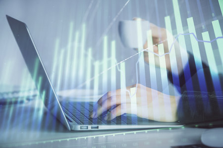 Double exposure of businesswoman hands typing on computer and forex graph hologram drawing. Financial analysis concept.の写真素材