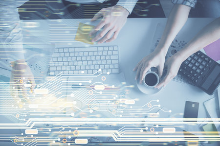 Double exposure of man and woman working together and data theme hologram drawing. Computer background. Top View.の写真素材