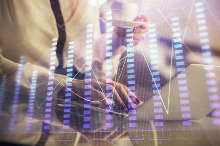 Double exposure of businesswoman hands typing on computer and financial graph hologram drawing. Stock market analysis concept.の写真素材