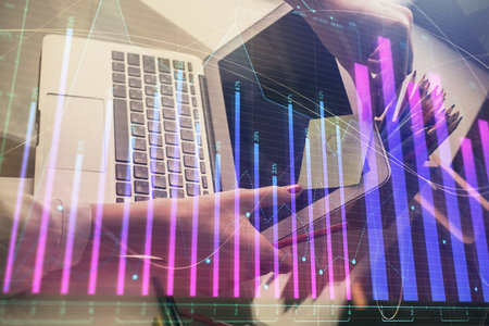 Double exposure of businesswoman hands typing on computer and financial graph hologram drawing. Stock market analysis concept.の写真素材