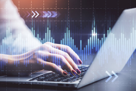 Double exposure of businesswoman hands typing on computer and forex chart hologram drawing. Financial analysis concept.の写真素材