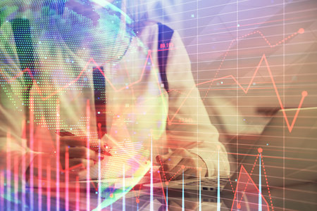 Double exposure of businesswoman hands typing on computer and financial graph hologram drawing. Stock market analysis concept.の写真素材