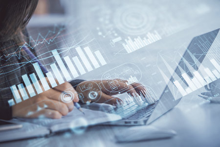 Double exposure of businesswoman hands typing on computer and forex graph hologram drawing. Financial analysis concept.の写真素材