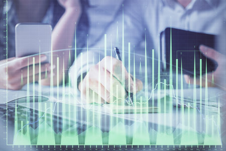 Double exposure of man and woman working together and financial graph hologram. Business concept. Computer background.の写真素材