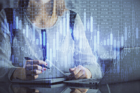 Double exposure of businesswoman hands typing on computer and financial graph hologram drawing. Stock market analysis concept.の写真素材
