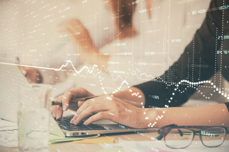 Multi exposure of woman hands typing on computer and financial graph hologram drawing. Stock market analysis concept.の写真素材