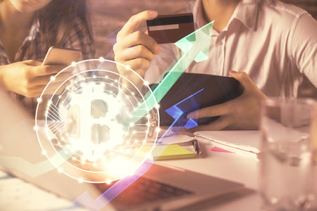 Double exposure of man and woman on-line shopping holding a credit card and crypto theme hologram drawing. Blockchain and E-commerce pay on-line concept.の写真素材