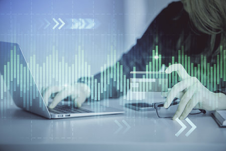 Double exposure of woman on-line shopping holding a credit card and financial graph drawing. Stock market E-commerce concept.の写真素材