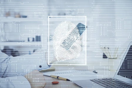 Double exposure of man's hands holding and using a digital device and fingerprint hologram drawing. Security concept.の写真素材