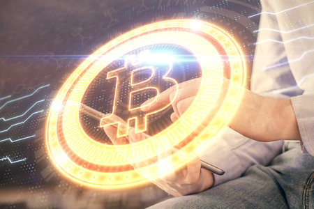 Double exposure of man's hands holding and using a phone and crypto currency blockchain theme drawing.の写真素材