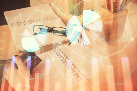 Multi exposure of woman on-line shopping holding a credit card and financial graph drawing. Stock market E-commerce concept.の写真素材