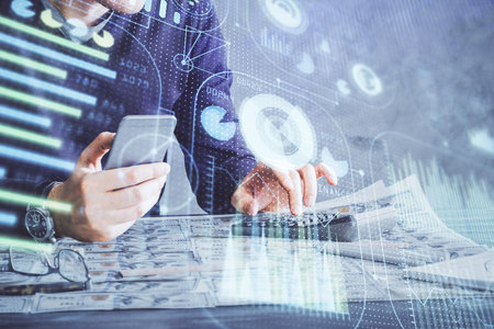 Double exposure of man's hand holding and using a digital device and data theme drawing. Technology concept.の写真素材