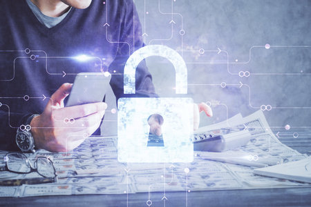 Multi exposure of man's hands holding and using a digital device and lock drawing. Security concept.の写真素材