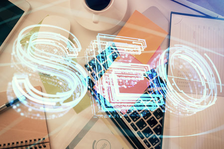 Double exposure of SEO drawing over study table background with computer. Concept of search. Top view.の写真素材