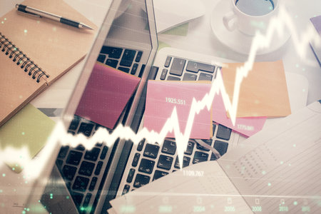 Multi exposure of financial chart drawing over table background with computer. Concept of research and analysis. Top view.の写真素材