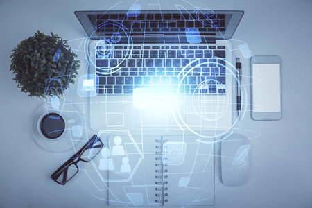 Social network hologram drawings over computer on the desktop background. Top view. Multi exposure. Concept of people connection.の写真素材