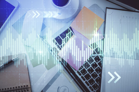 Multi exposure of financial chart drawing over table background with computer. Concept of research and analysis. Top view.の写真素材