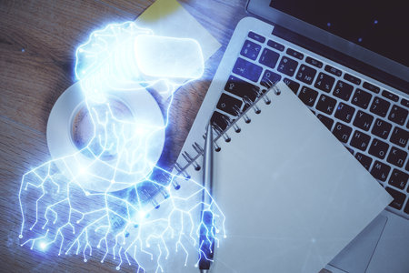 AR hologram drawings over computer on the desktop background. Top view. Multi exposure. Concept of augmented reality.の写真素材