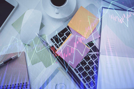Multi exposure of financial chart drawing over table background with computer. Concept of research and analysis. Top view.の写真素材