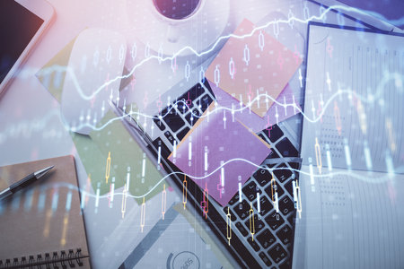 Multi exposure of financial chart drawing over table background with computer. Concept of research and analysis. Top view.の写真素材