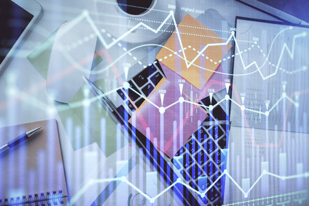 Multi exposure of financial chart drawing over table background with computer. Concept of research and analysis. Top view.の写真素材