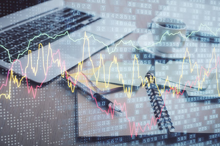 Multi exposure of forex graph drawing and desktop with coffee and items on table background. Concept of financial market tradingの写真素材