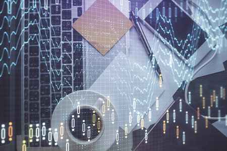 Double exposure of financial chart drawing over table background with computer. Concept of research and analysis. Top view.の写真素材