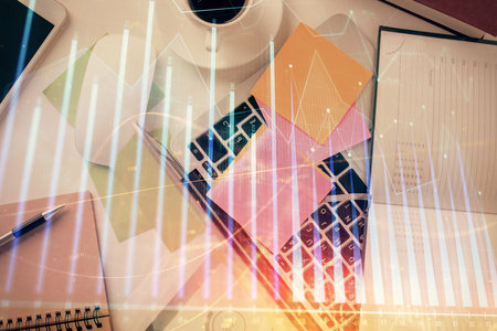 Multi exposure of financial chart drawing over table background with computer. Concept of research and analysis. Top view.の写真素材